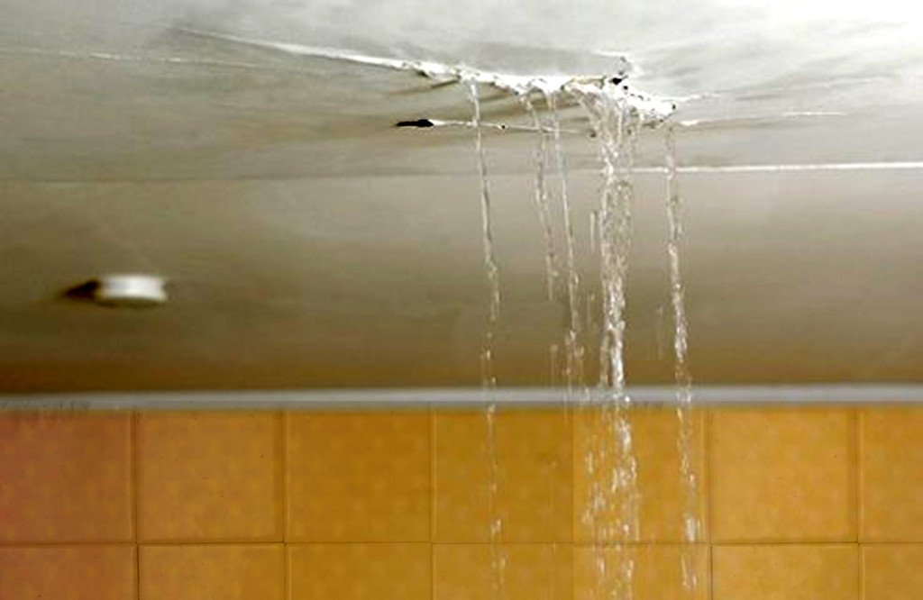 Plumber repairing a leaking geyser